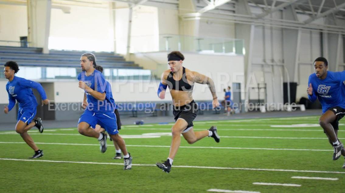 Image of three males running on indoor turf